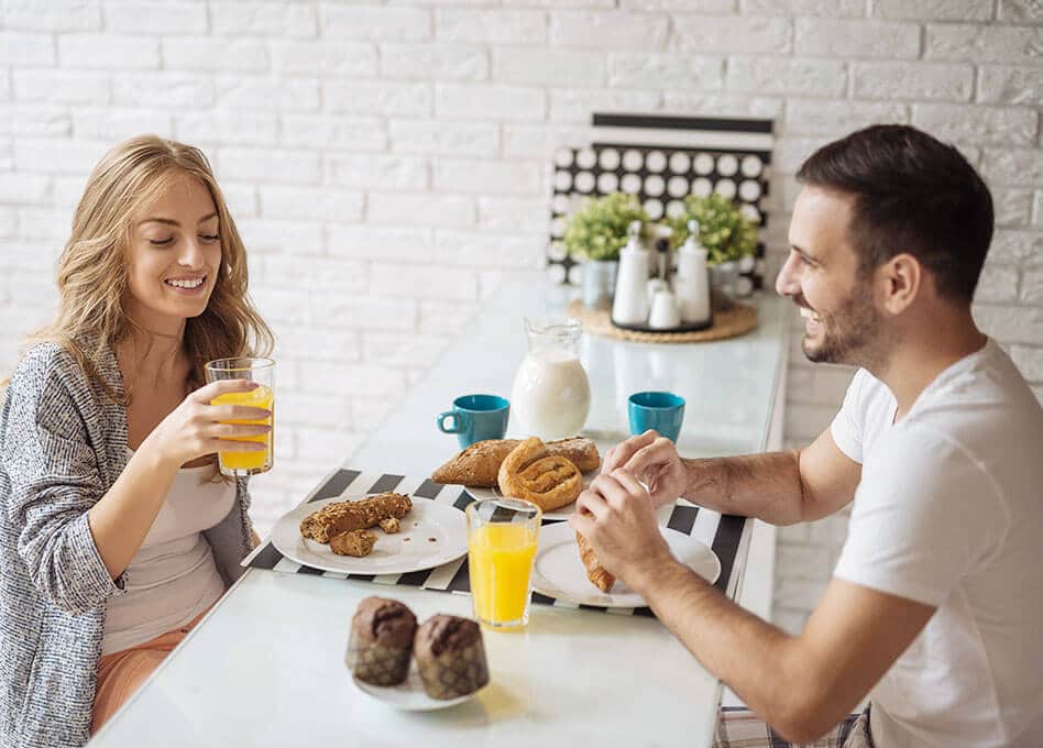 happy couple having a healthy breakfast