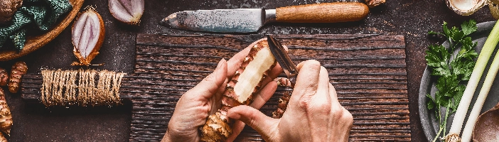 person cutting ginger - other paleo foods on the side