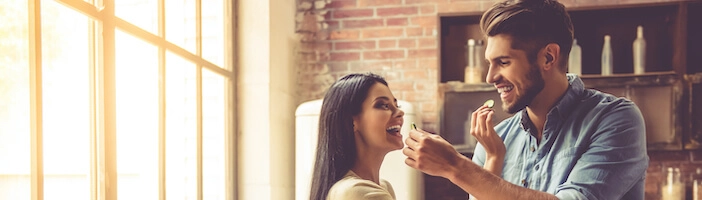 happy couple in the kitchen cooking